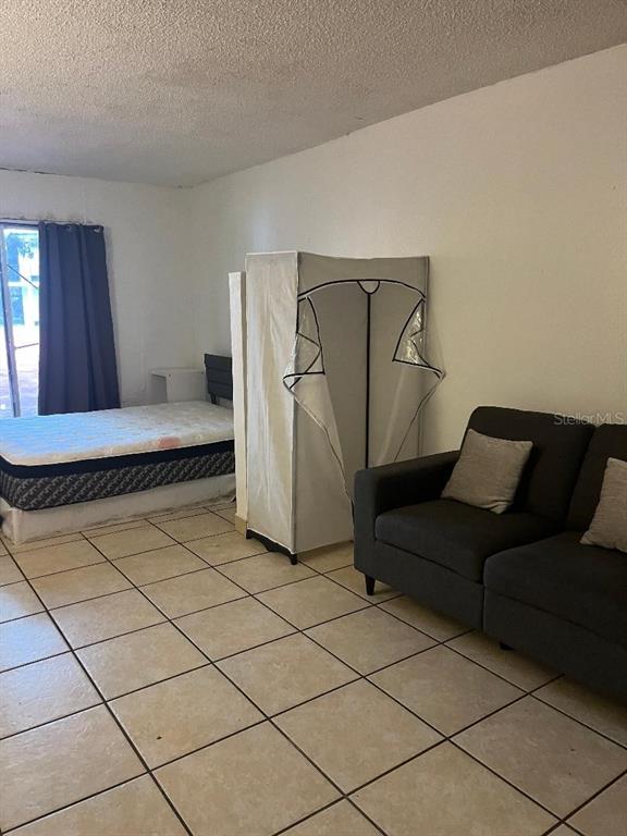 8421 South Orange Blossom Trail, Unit 303 Orlando, FL 32809 - Photo 13 of 15 a living room with a couch and a walk in closet