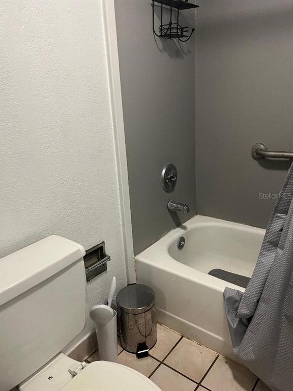 8421 South Orange Blossom Trail, Unit 303 Orlando, FL 32809 - Photo 8 of 15 a white toilet sitting next to a bath tub