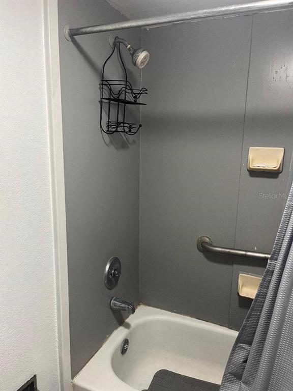 8421 South Orange Blossom Trail, Unit 303 Orlando, FL 32809 - Photo 9 of 15 a bathroom with a sink and shower