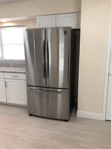 a kitchen with granite countertop a sink and a stove