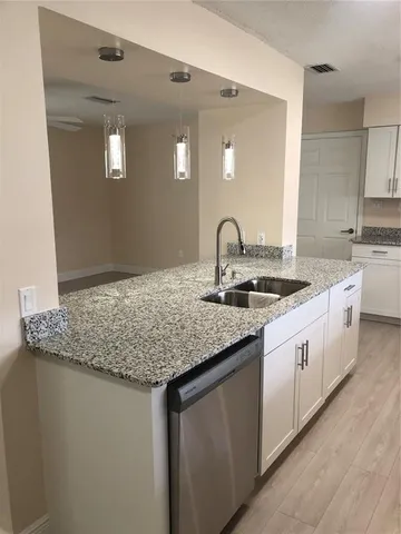 a kitchen with a sink and cabinets