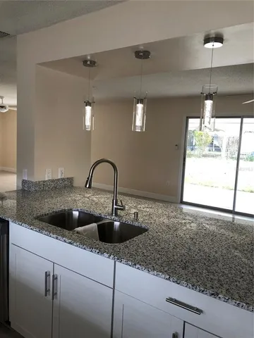 a metallic refrigerator freezer sitting in a kitchen