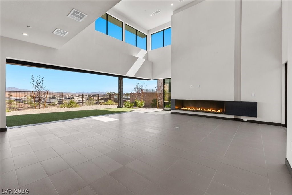 36 Rainbow Point Place Henderson, NV 89011 - Photo 8 of 34 Living Room|Dining Area|Pocket Doors| Linear Fireplace