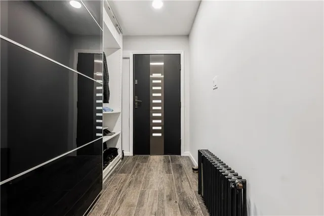 a view of hallway with wooden floor