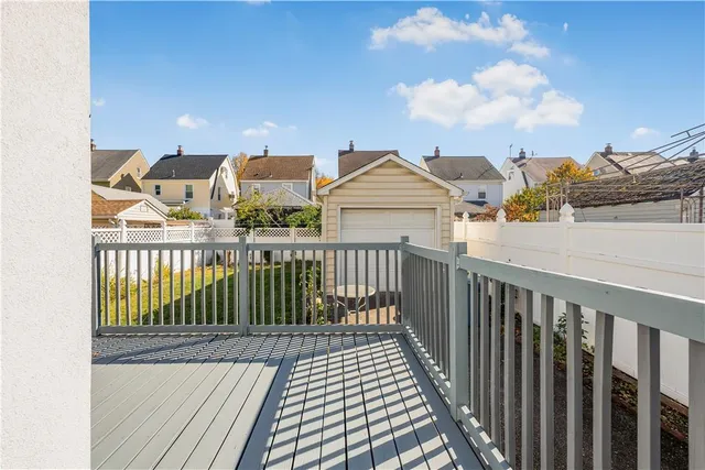 a view of a balcony with wooden fence