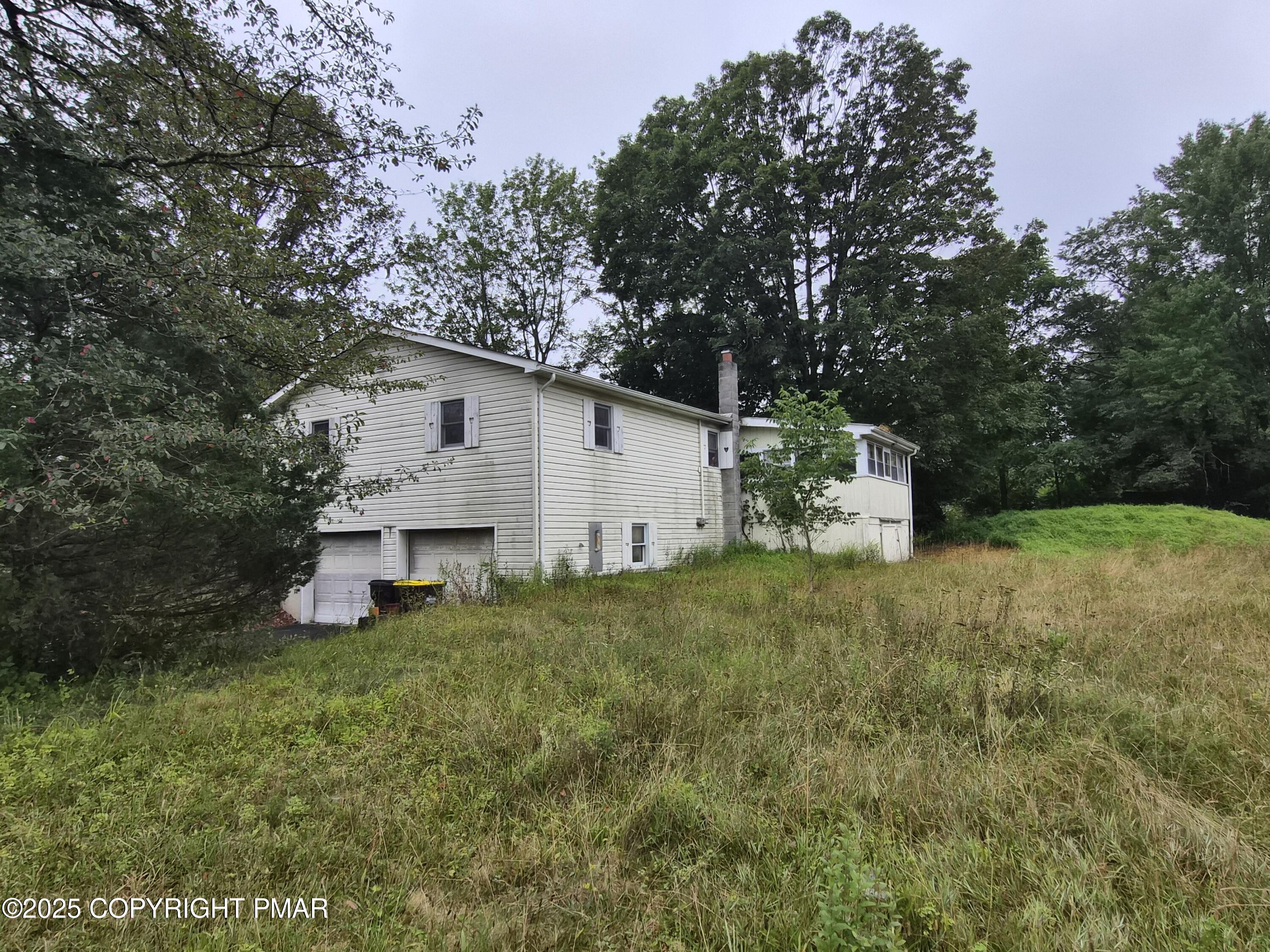 113 Olsen Road Stroudsburg, PA 18360 - Photo 2 of 22 a view of a house with backyard and garden