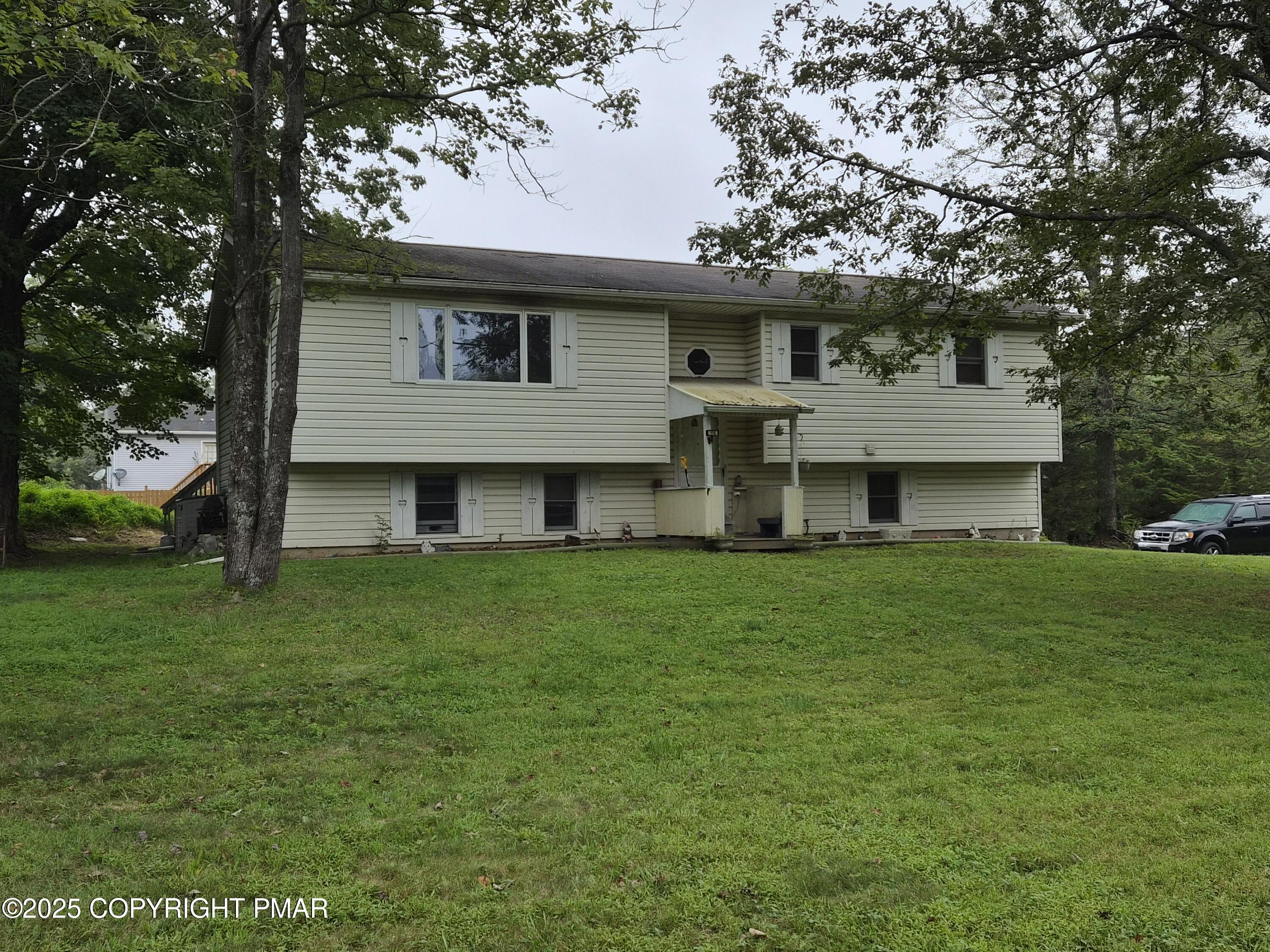 113 Olsen Road Stroudsburg, PA 18360 - Photo 22 of 22 a view of a yard in front of a house with large trees