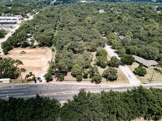 an aerial view of a house with a yard and lake view