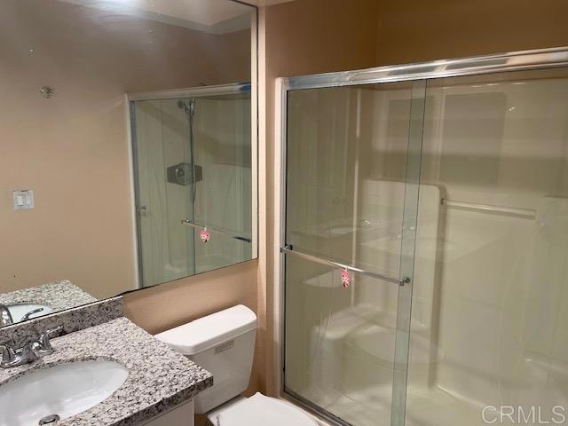 11417 Poblado Road San Diego, CA 92127 - Photo 19 of 37 a bathroom with a granite countertop shower and a toilet