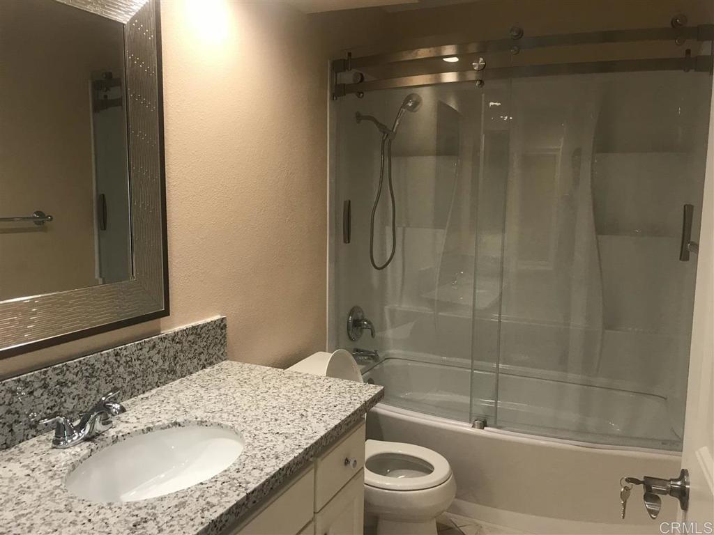 11417 Poblado Road San Diego, CA 92127 - Photo 20 of 37 a bathroom with a granite countertop sink toilet and shower