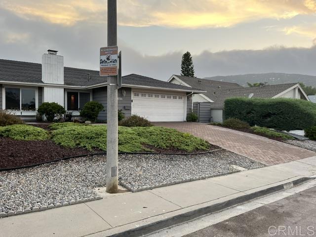 11417 Poblado Road San Diego, CA 92127 - Photo 2 of 37 a front view of a house with a yard and garage