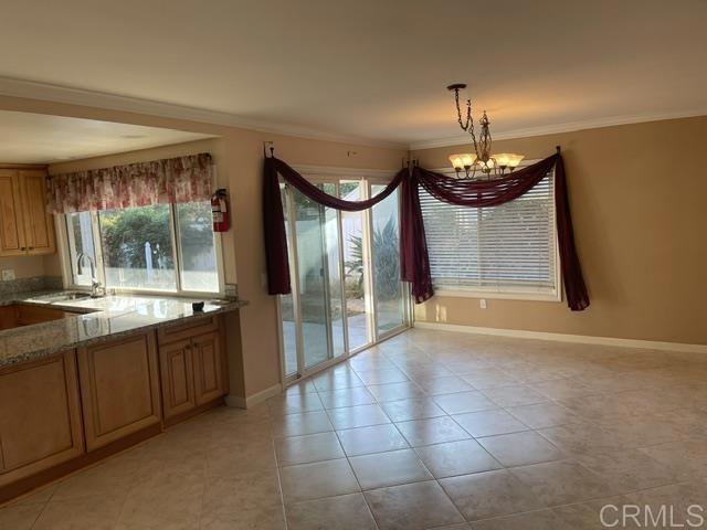 11417 Poblado Road San Diego, CA 92127 - Photo 22 of 37 a view of a kitchen with a sink and a chandelier