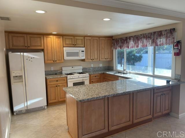 11417 Poblado Road San Diego, CA 92127 - Photo 23 of 37 a kitchen with a sink a counter top space cabinets and stainless steel appliances