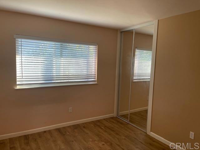 11417 Poblado Road San Diego, CA 92127 - Photo 25 of 37 an empty room with wooden floor and a window