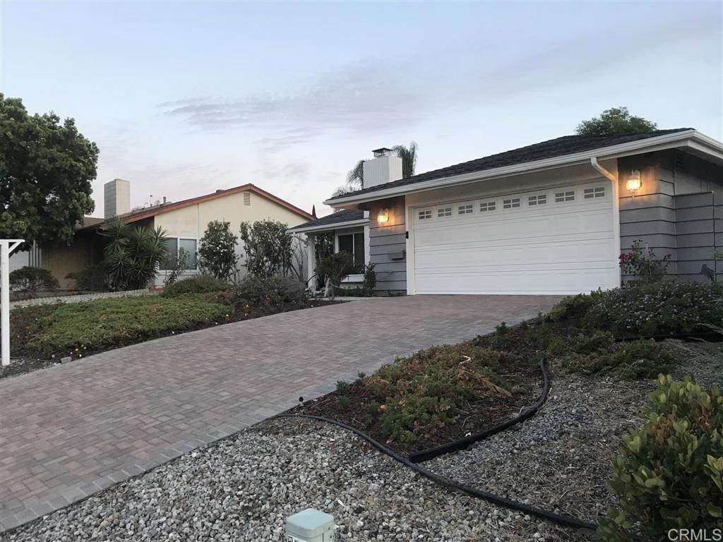 11417 Poblado Road San Diego, CA 92127 - Photo 28 of 37 a front view of a house with a yard and garage