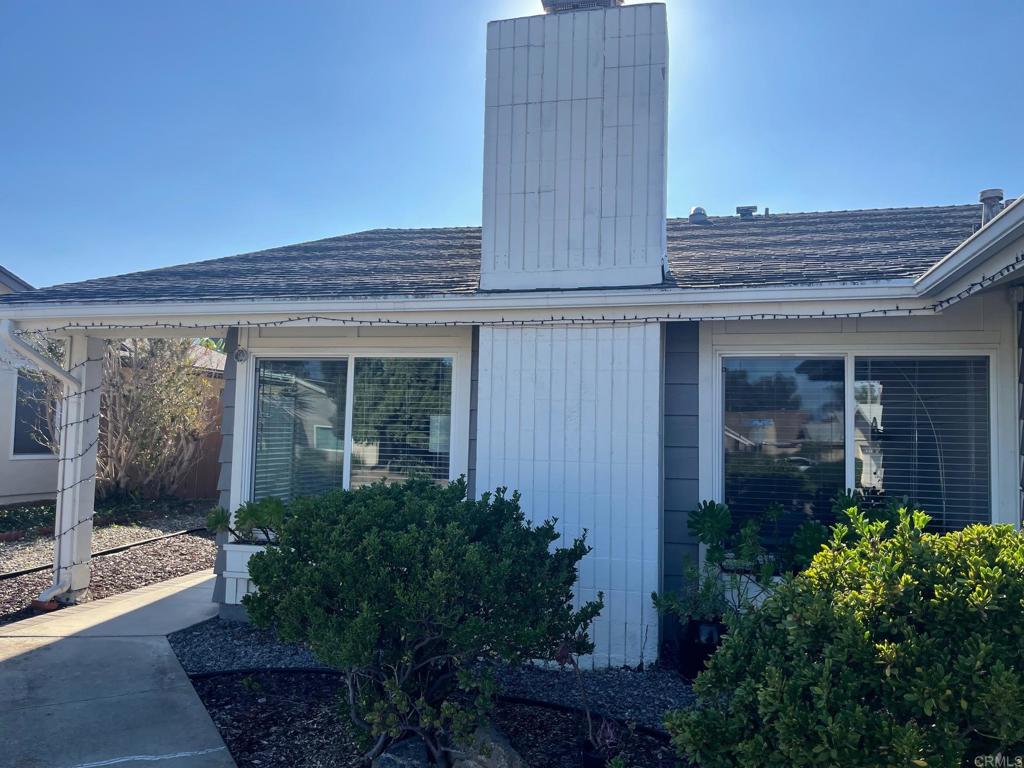 11417 Poblado Road San Diego, CA 92127 - Photo 30 of 37 a view of a house with potted plants and a table and chairs