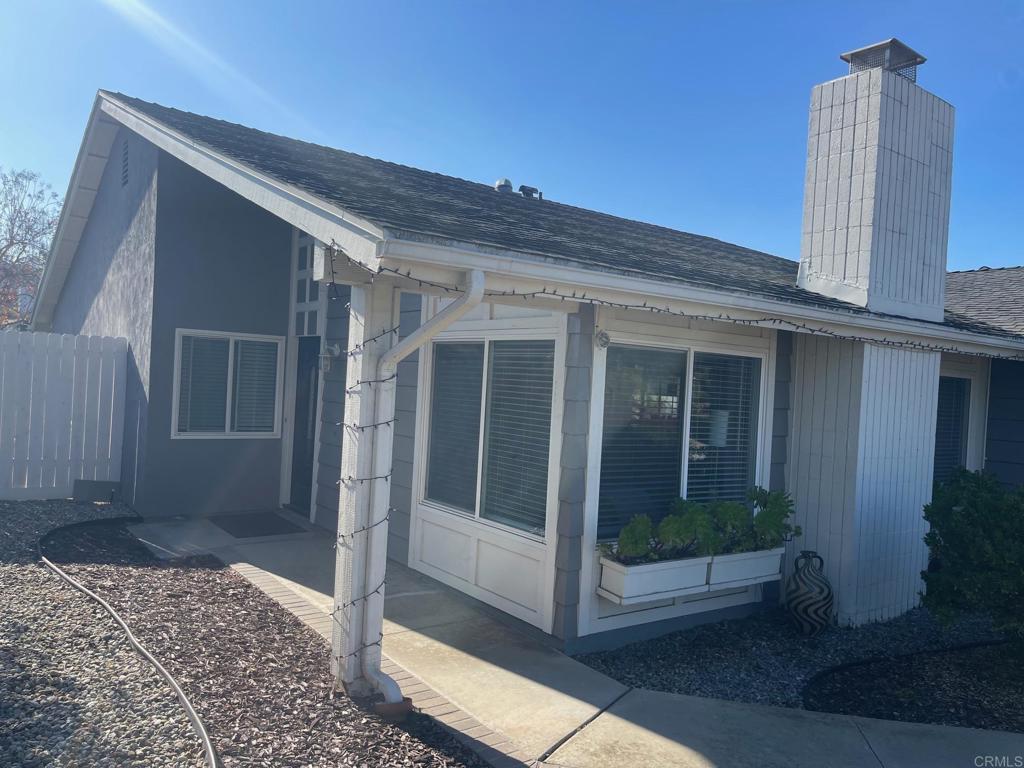 11417 Poblado Road San Diego, CA 92127 - Photo 34 of 37 a view of a porch with a floor to ceiling window and potted plants