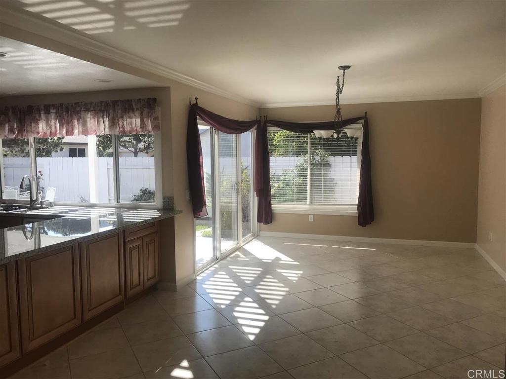 11417 Poblado Road San Diego, CA 92127 - Photo 8 of 37 a open kitchen with granite countertop a refrigerator and a sink