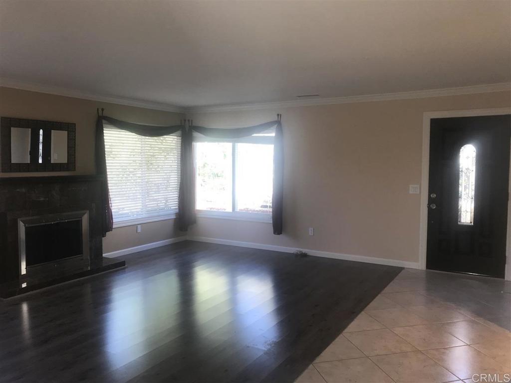 11417 Poblado Road San Diego, CA 92127 - Photo 10 of 37 an empty room with wooden floor and windows