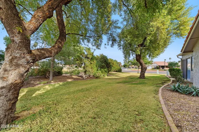 a living room with lots of furniture and painting on the wall