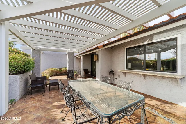 a living room with furniture kitchen view and a chandelier