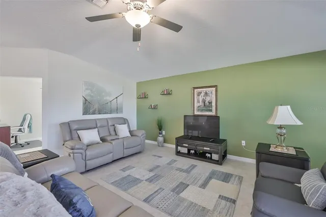 a living room with furniture and a lamp