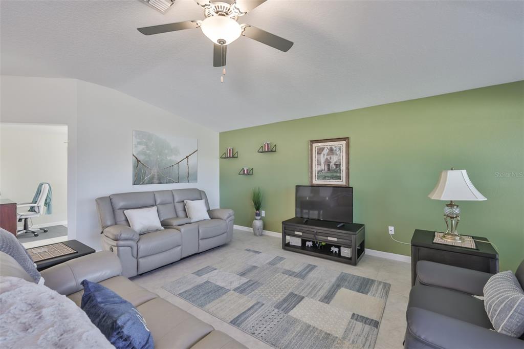 13575 Willow Bluestar Loop Riverview, FL 33579 - Photo 11 of 48 a living room with furniture and a lamp
