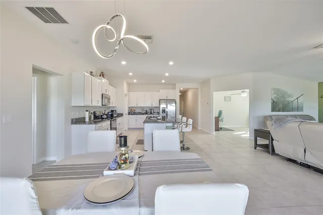 a living room with furniture and kitchen view