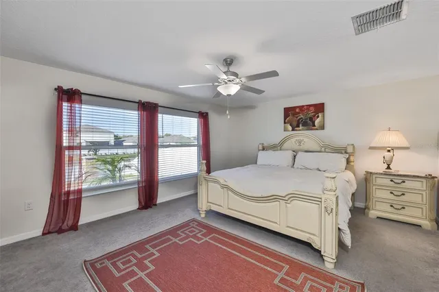 a spacious bedroom with a large bed and a window