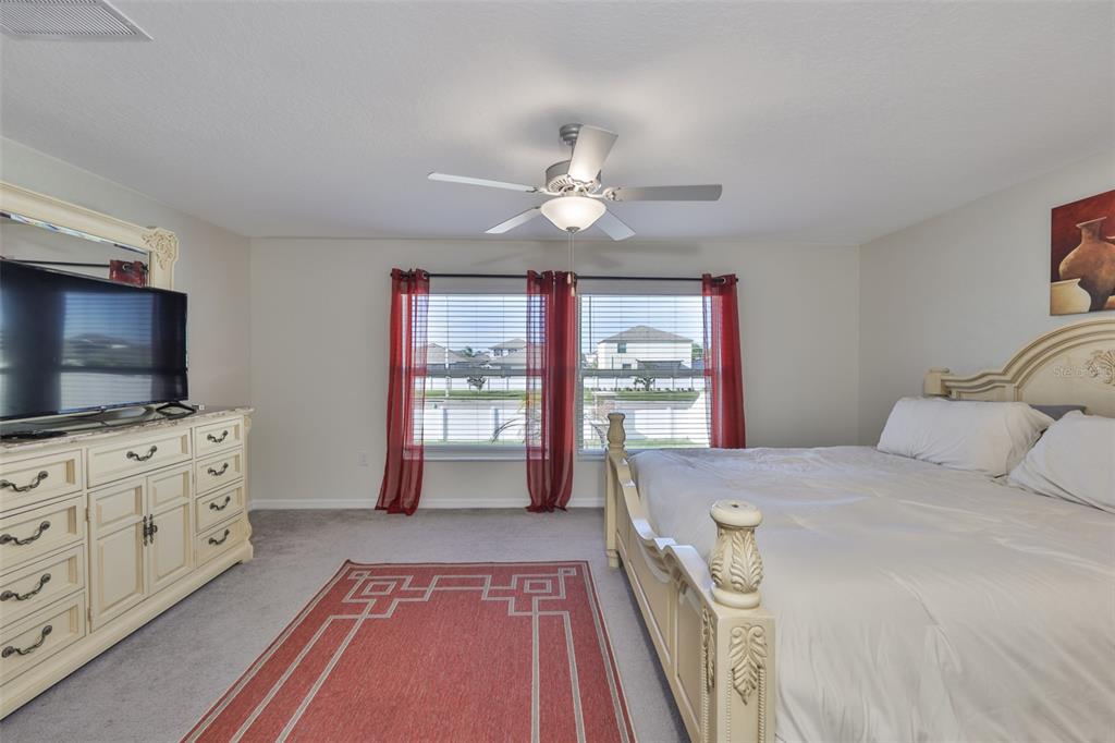 13575 Willow Bluestar Loop Riverview, FL 33579 - Photo 20 of 48 a bedroom with a bed and a flat screen tv