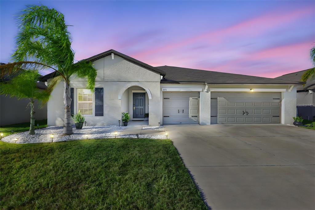 13575 Willow Bluestar Loop Riverview, FL 33579 - Photo 2 of 48 a front view of a house with a yard and garage