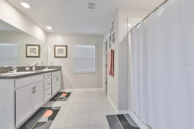 a bathroom with a sink a mirror and a shower