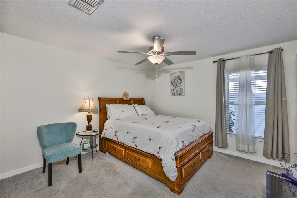 13575 Willow Bluestar Loop Riverview, FL 33579 - Photo 31 of 48 a bed room with a bed and a chandelier