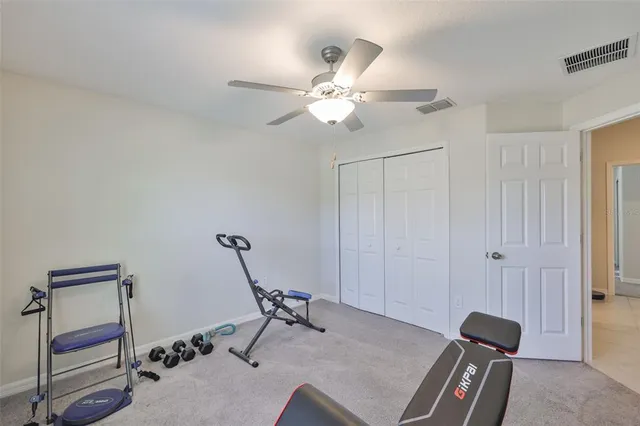 a room with gym equipment and a chandelier