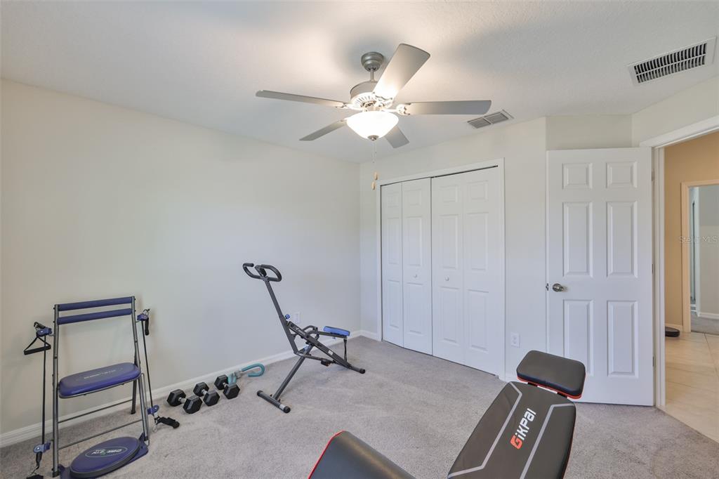 13575 Willow Bluestar Loop Riverview, FL 33579 - Photo 33 of 48 a room with gym equipment and a chandelier