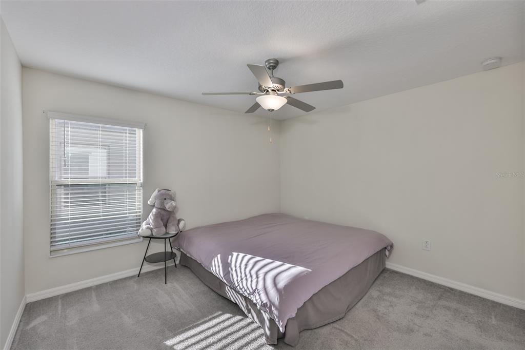 13575 Willow Bluestar Loop Riverview, FL 33579 - Photo 37 of 48 a bedroom with a bed and a chandelier