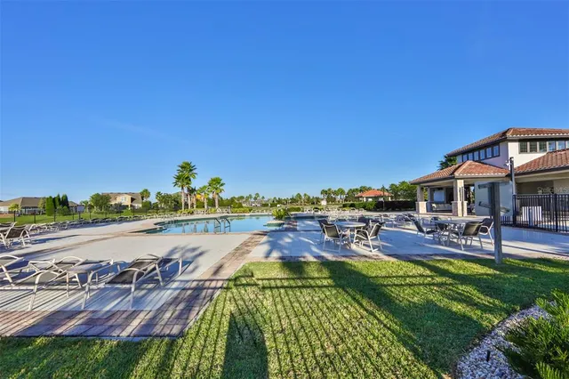 an aerial view of a swimming pool and lounge chairs