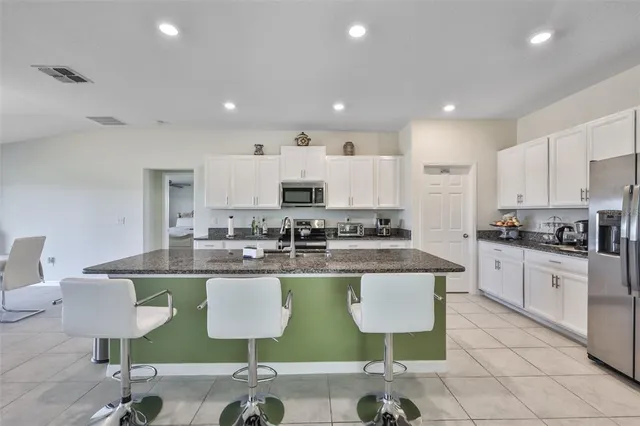 a kitchen with lots of counter top space cabinets and stainless steel appliances