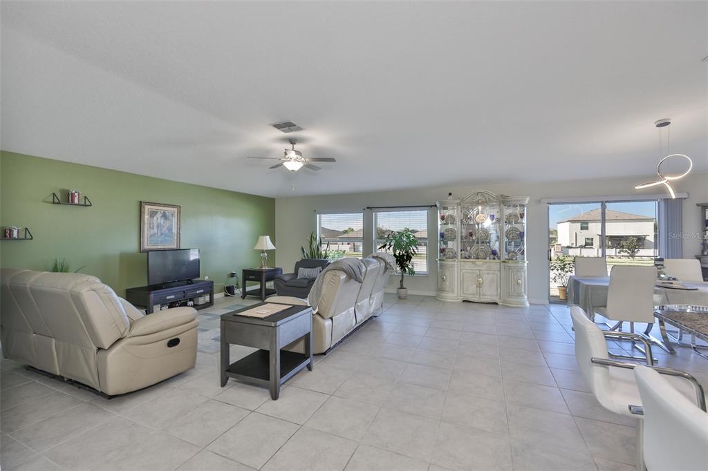 13575 Willow Bluestar Loop Riverview, FL 33579 - Photo 8 of 48 a living room with furniture and a chandelier