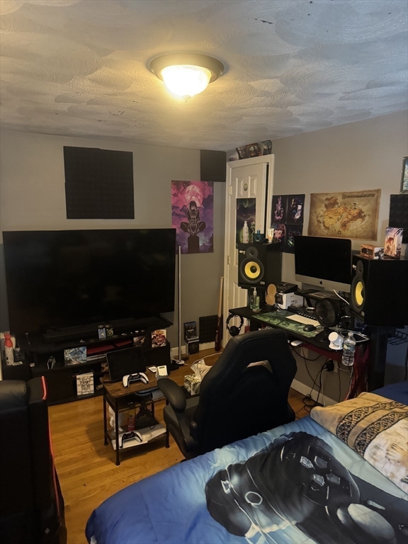 21 Cook, Unit 1 Chelsea, MA 02150 - Photo 8 of 32 a room with furniture and a flat screen tv