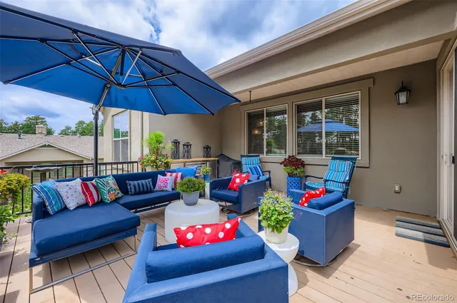 a outdoor living space with furniture and umbrella