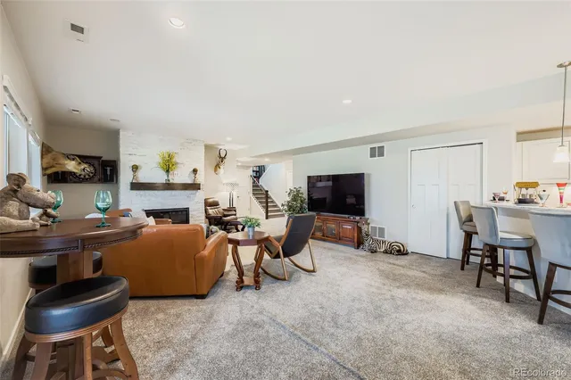 a living room with furniture a flat screen tv and a window