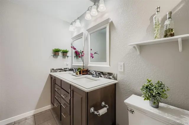 a bathroom with a sink vanity and mirror