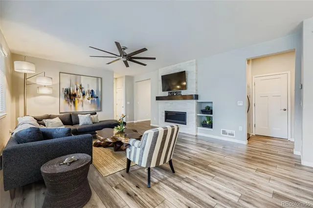 a living room with furniture a fireplace and a flat screen tv