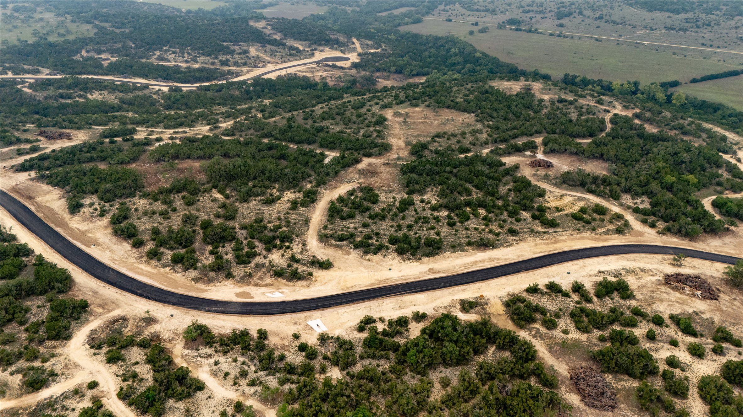 Lot 21 Ranch Road 165 Dripping Springs, TX 78620 - Photo 2 of 8 Expansive undeveloped acreage featuring a newly paved winding road