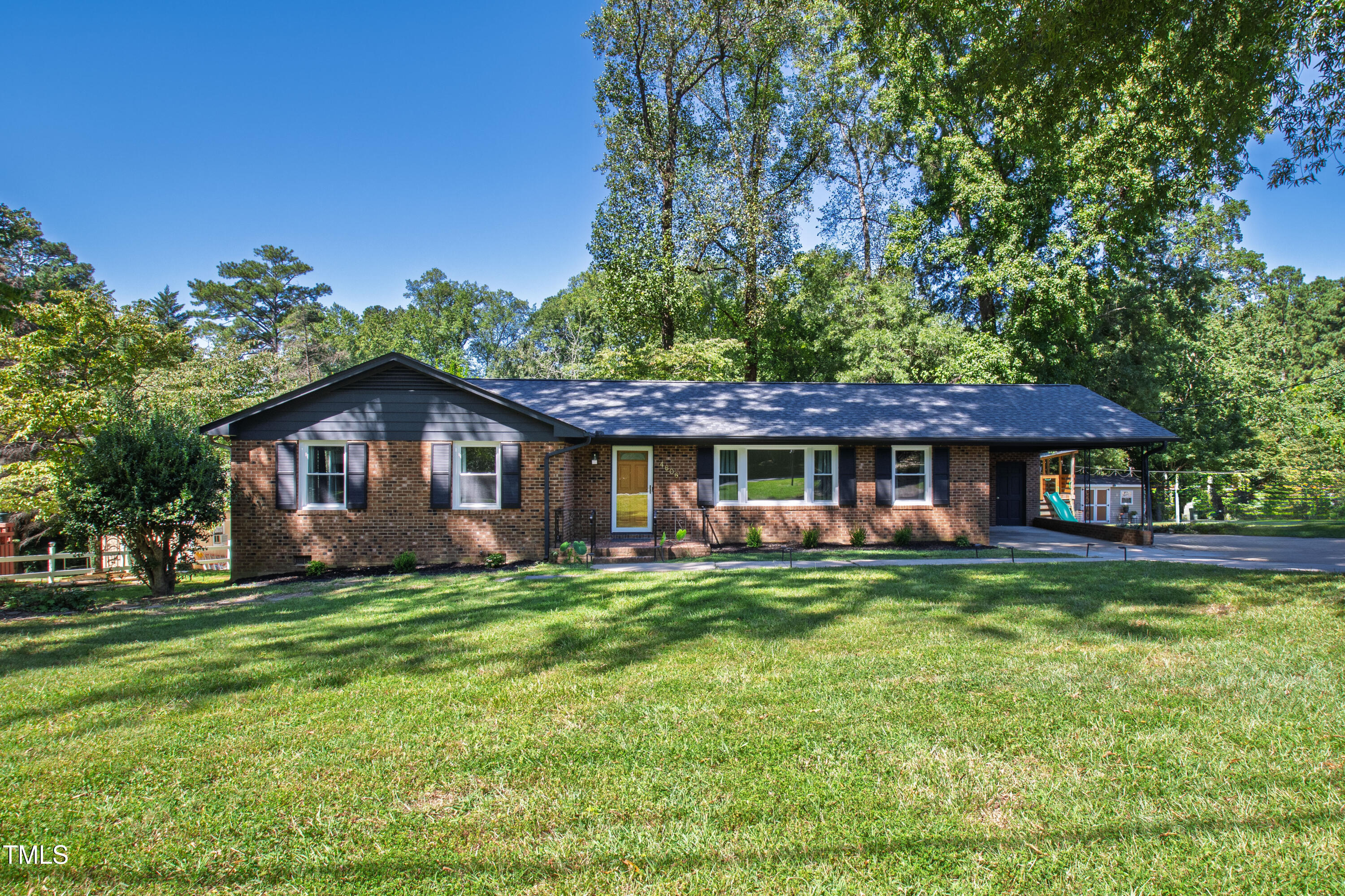 4606 Greenbrier Road Raleigh, NC 27603 - Photo 1 of 49 a front view of a house with a garden