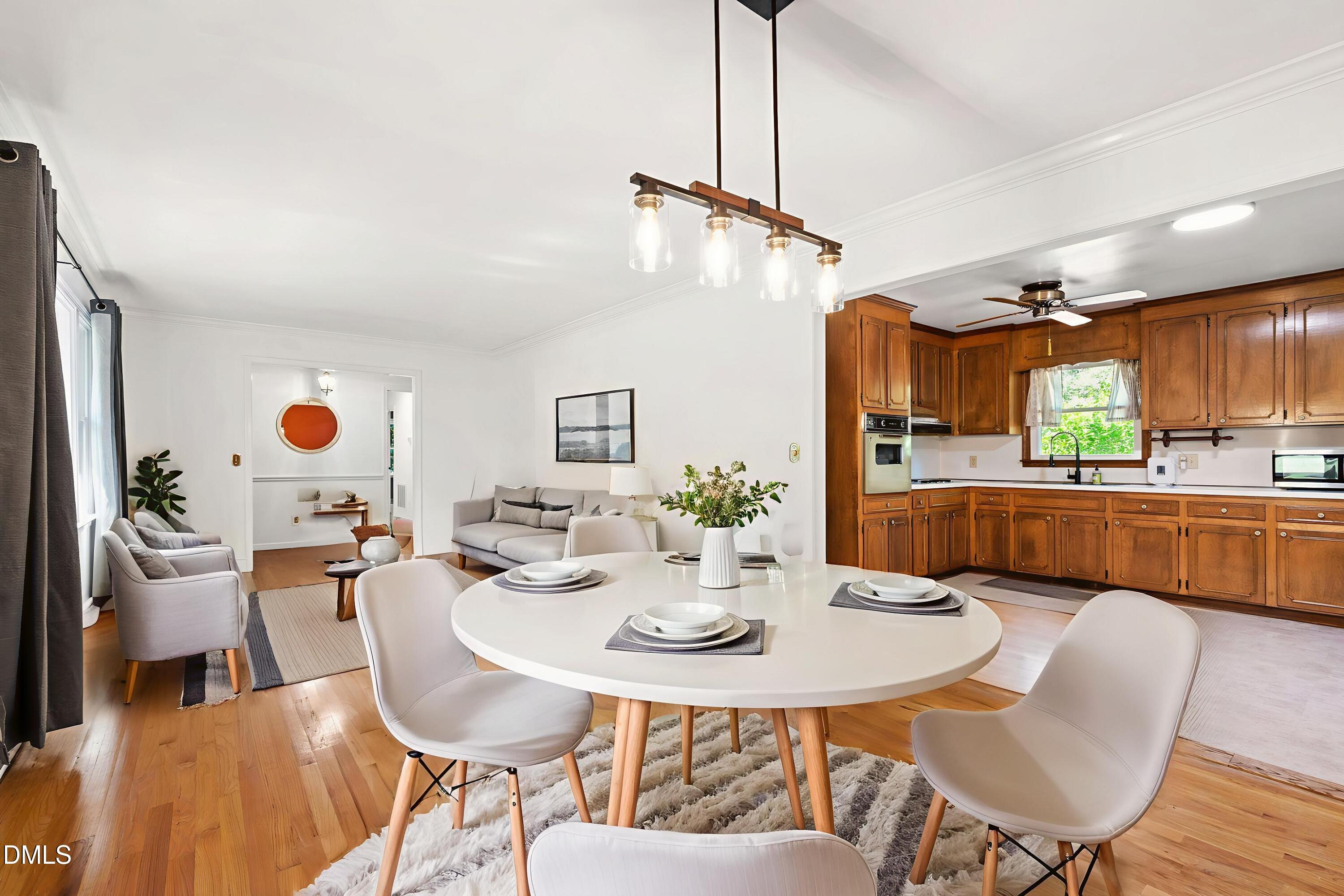 4606 Greenbrier Road Raleigh, NC 27603 - Photo 11 of 49 a view of a dining room with furniture and wooden floor