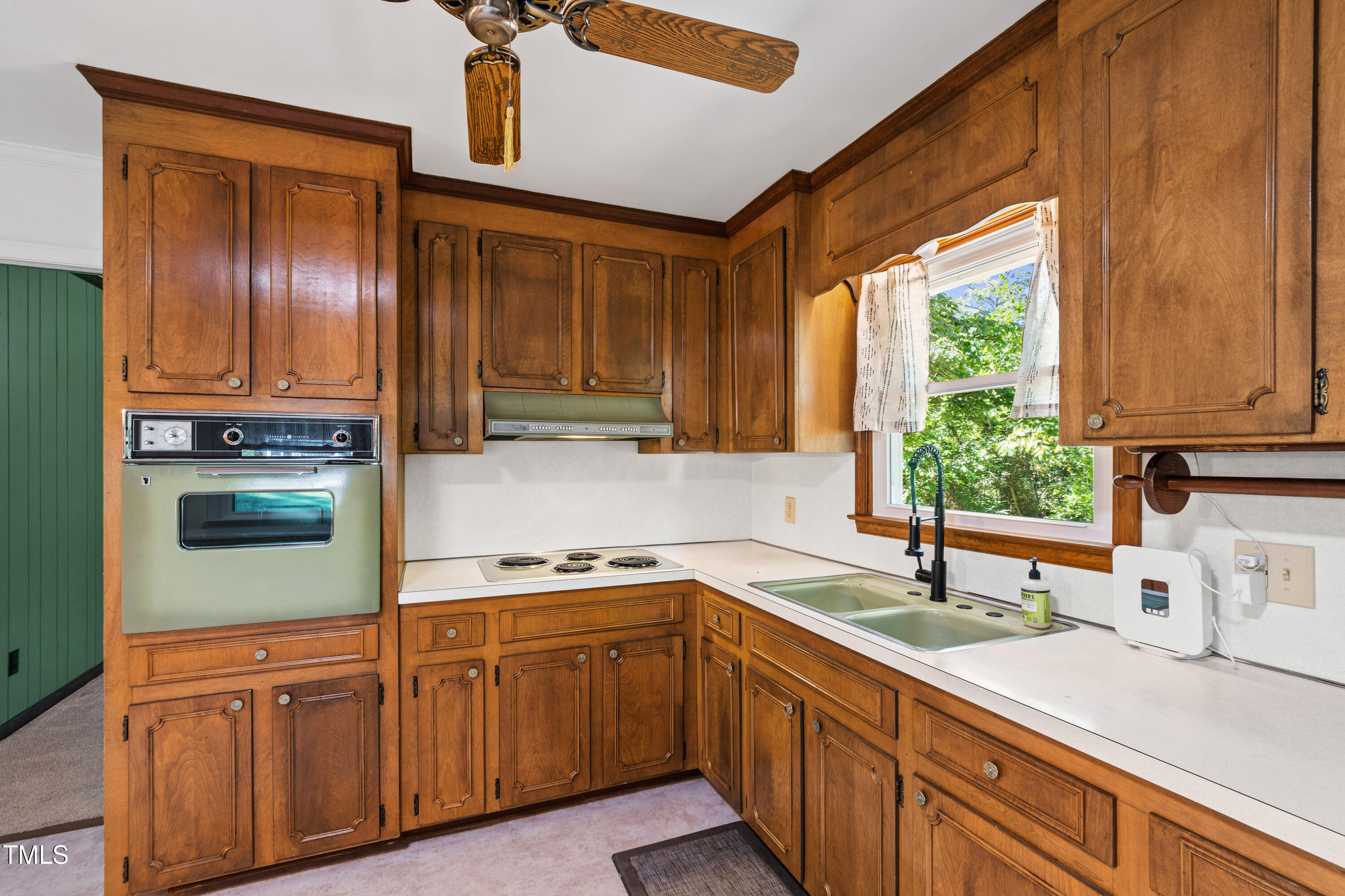 4606 Greenbrier Road Raleigh, NC 27603 - Photo 15 of 49 a kitchen with stainless steel appliances granite countertop a sink dishwasher stove and cabinets with wooden floor