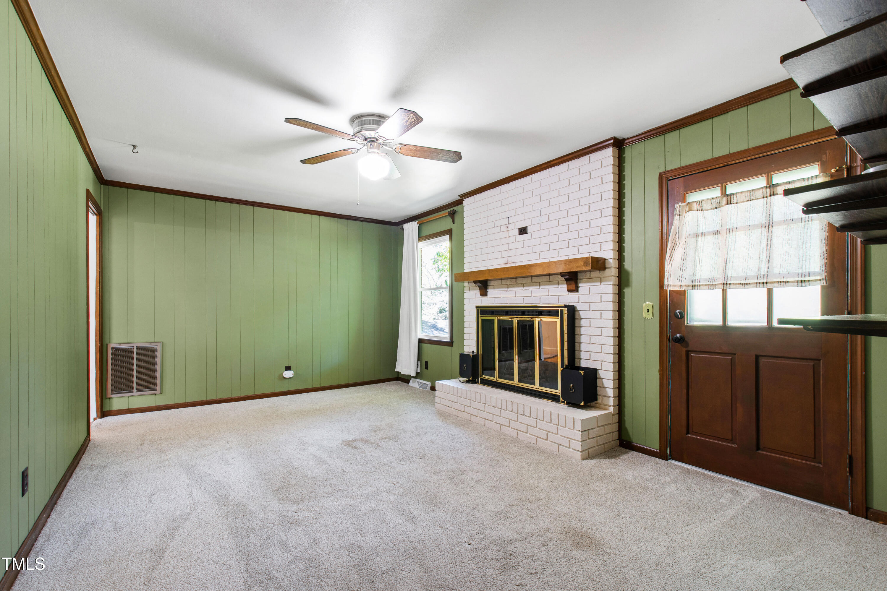 4606 Greenbrier Road Raleigh, NC 27603 - Photo 17 of 49 an empty room with fireplace chandelier and windows