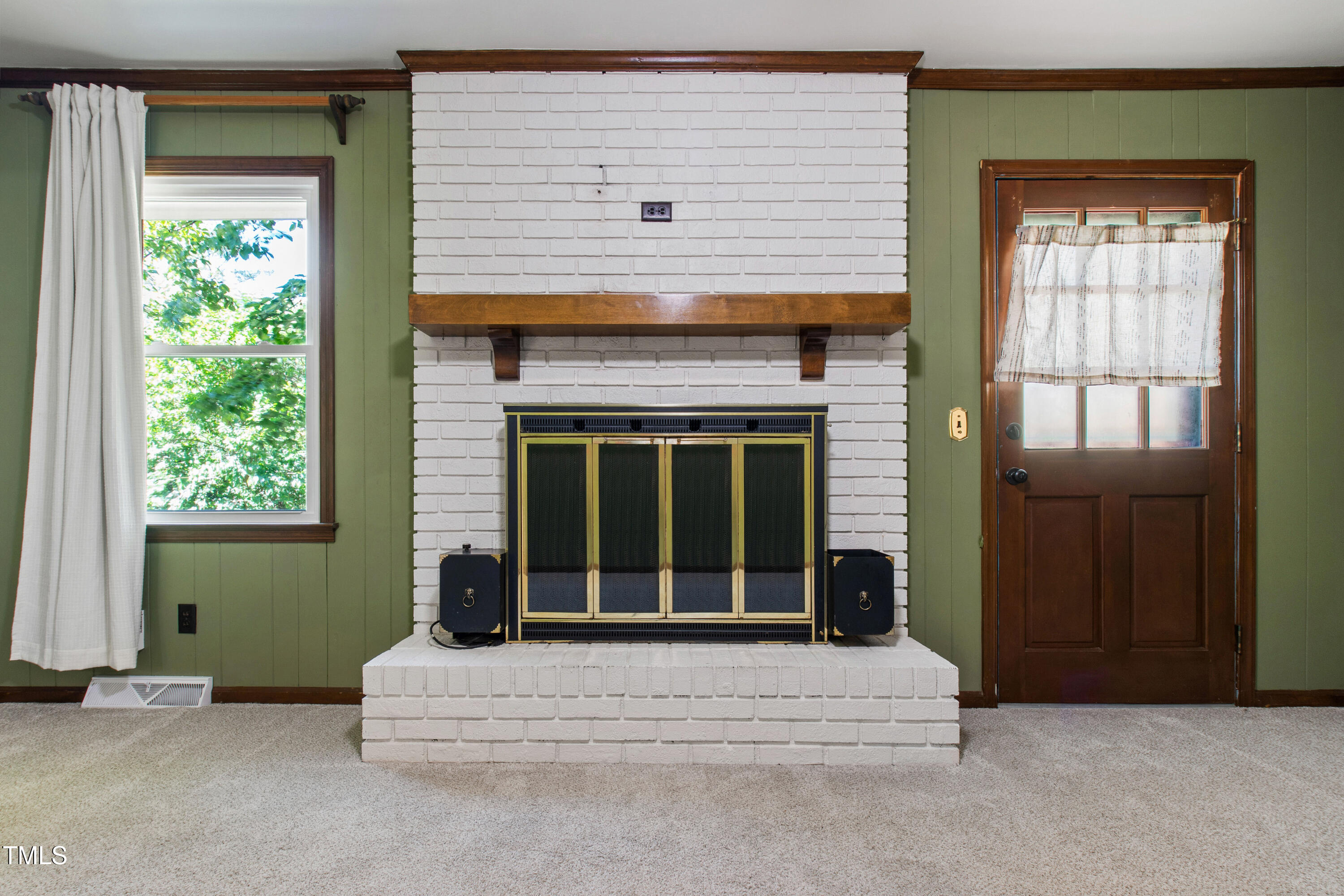 4606 Greenbrier Road Raleigh, NC 27603 - Photo 18 of 49 a living room with a large window and a fireplace